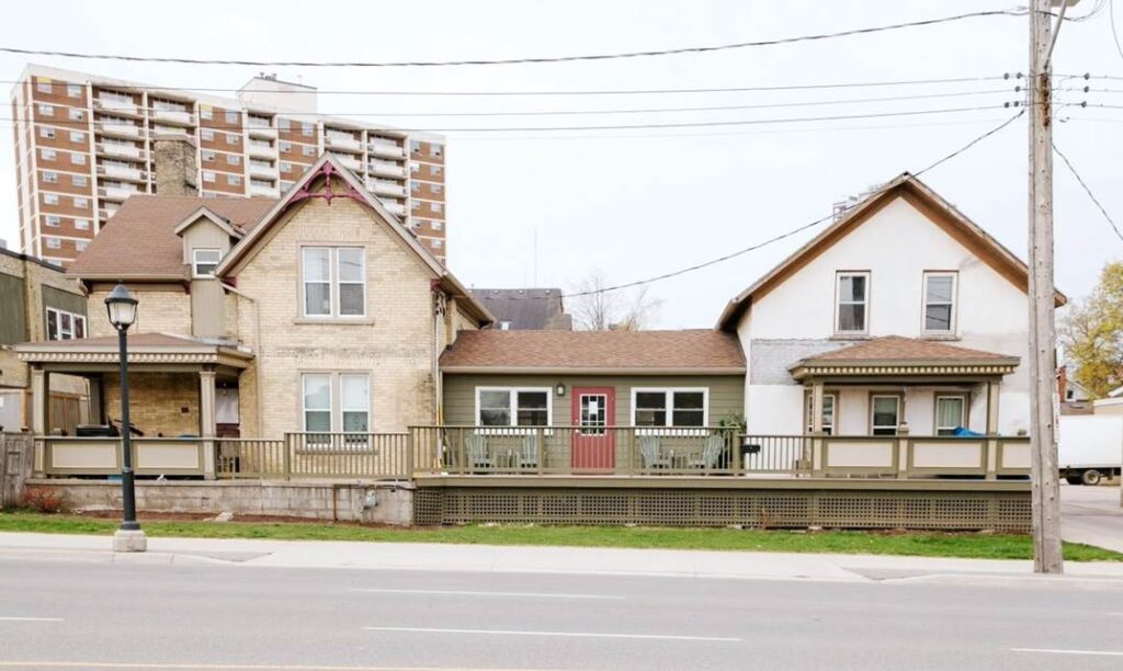 87 Victoria building consists of two houses with a central addition connecting them and a large exterior porch