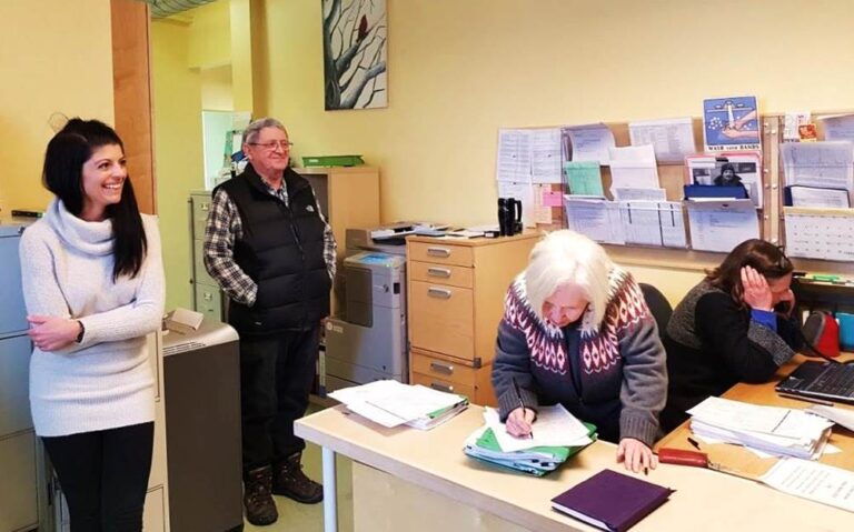 Staff sit and stand inside the former Saint John's Medical Clinic