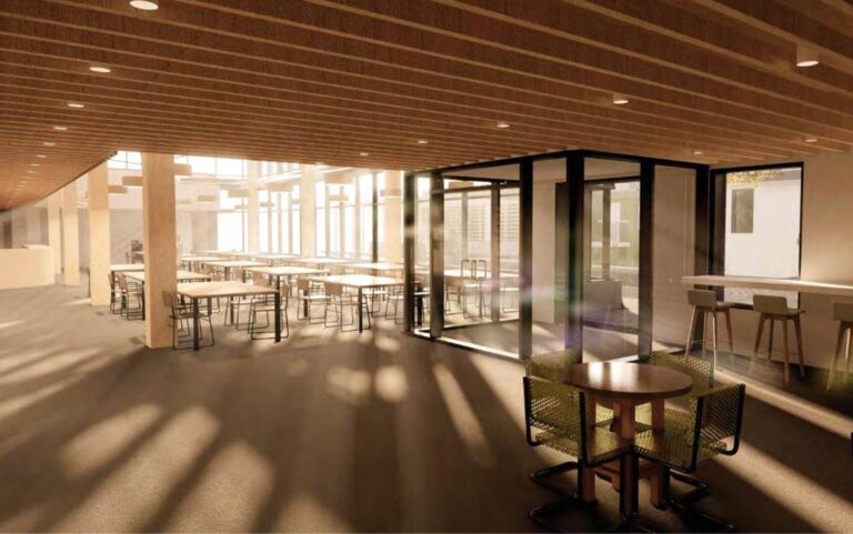 Computer generated image shows interior of the new proposed Saint John's Kitchen building. The entry and dining area are lit up with natural light from full glass exterior wall.