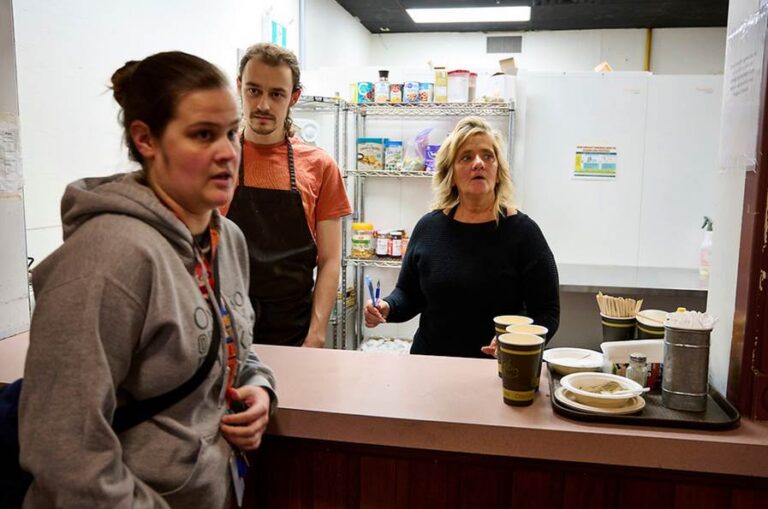 Staff member stand in the kitchen area of King St. Emergency Shelter