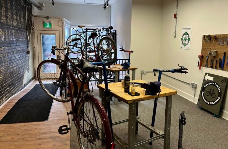 Bicycles affixed to work stations inside the Recycle Cycles community bike shop