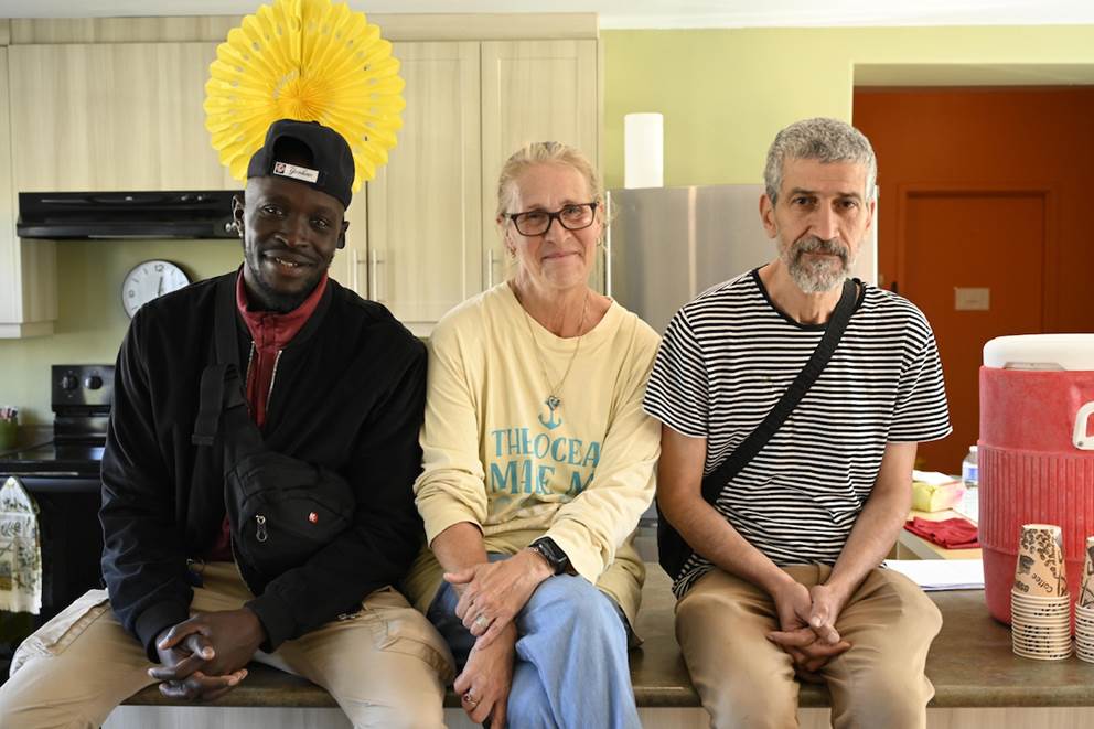 Staff members, two men and one woman sit inside 87 Victoria building