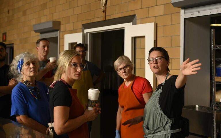 A group of staff and volunteers in discussion at St. John's Kitchen