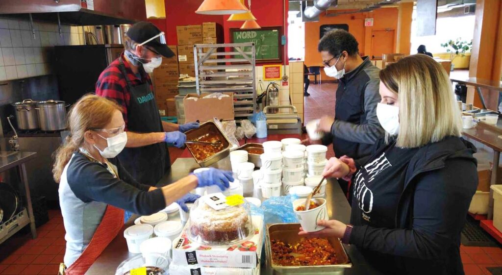 Staff and volunteers prepare and package meals at St. John's Kitchen